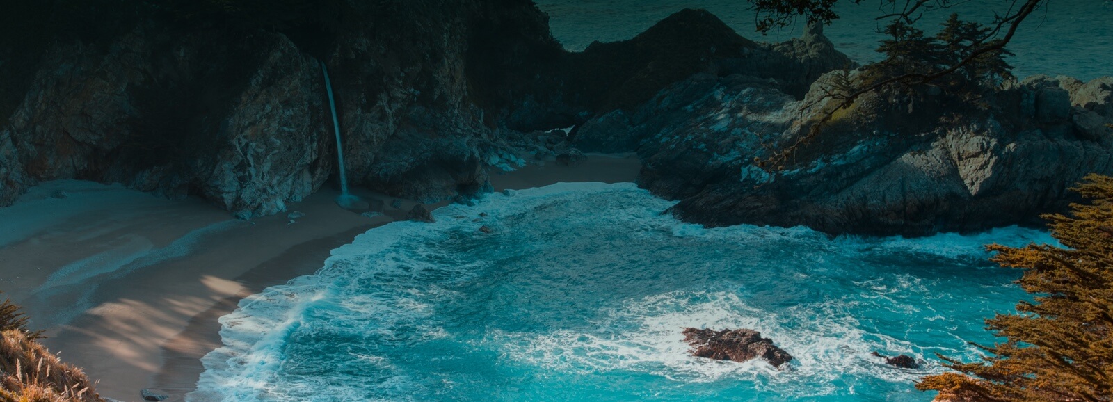 blue beach coast with surrounding rocks