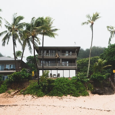 three-storey beach house with palm trees 