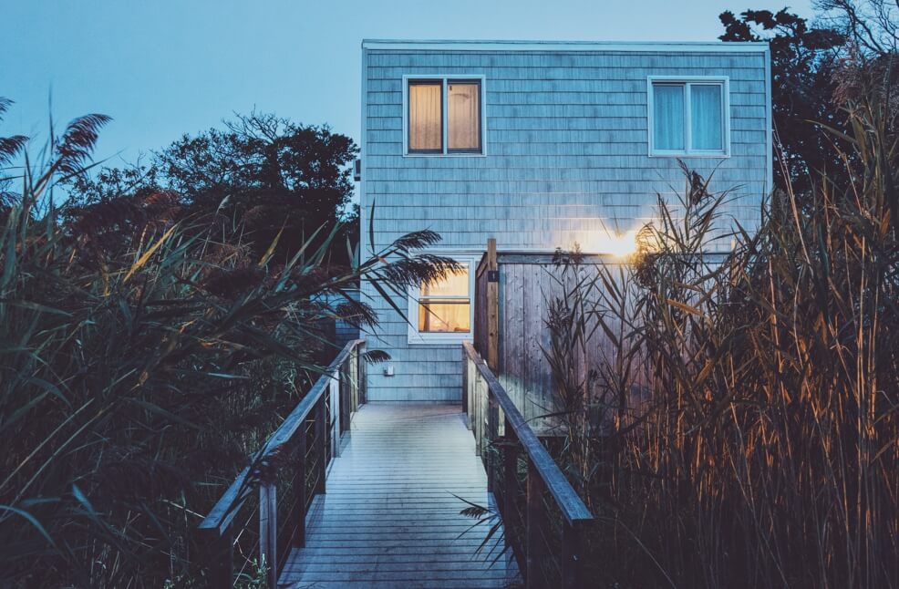 summer house at dusk with a garden of reed grass