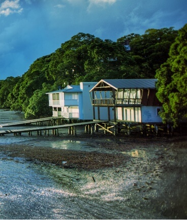 view of beach house with a dock on a river